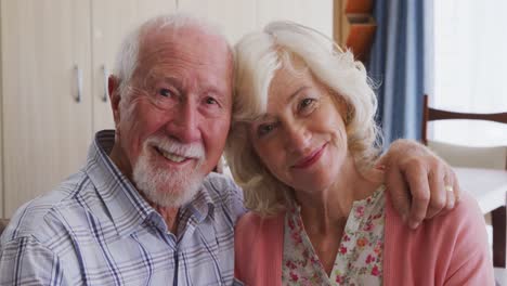 Senior-couple-in-social-distancing-smiling-at-camera
