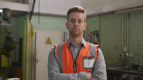 Caucasian-male-factory-worker-at-a-factory-wearing-a-high-vis-vest