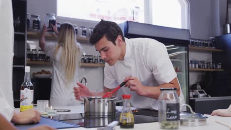 Caucasian-male-chef-wearing-chefs-whites-in-a-restaurant-kitchen-preparing-food