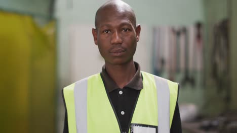 African-American-male-factory-worker-at-a-factory-wearing-a-high-vis-vest