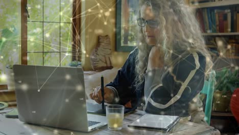 Web-of-connections-against-senior-woman-using-graphic-tablet