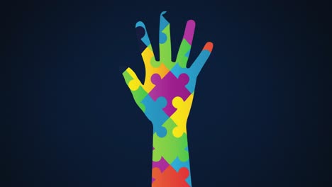 Animation-of-multi-coloured-puzzle-elements-forming-hand,-symbol-of-Autism-Awareness-Month-symbol-