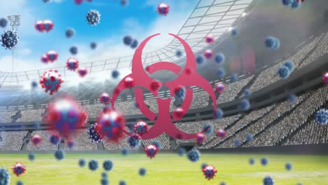 Bio-hazard-symbol-and-Covid-19-cells-against-empty-sports-stadium