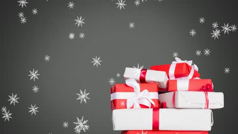 Digital-animation-of-snowflakes-falling-over-christmas-gifts-against-grey-background