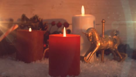 Animation-of-three-lit-candles-and-christmas-decorations