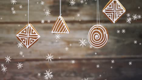 Animation-of-snow-falling-over-hanging-gingerbread-christmas-decoration