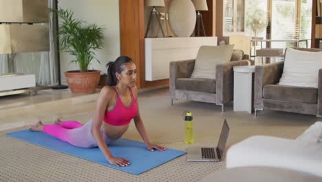Mixed-race-woman-practising-yoga-at-home