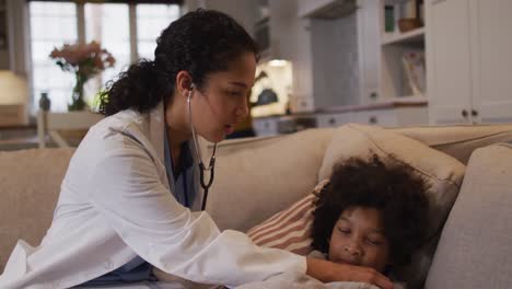 Mixed-race-female-doctor-examining-mixed-race-girl-at-home