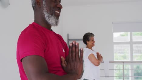 Diverse-group-of-seniors-taking-part-in-fitness-class-at-home