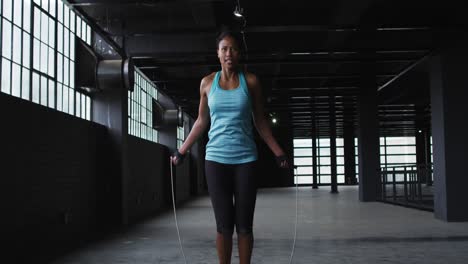 African-american-woman-skipping-the-rope-in-an-empty-urban-building