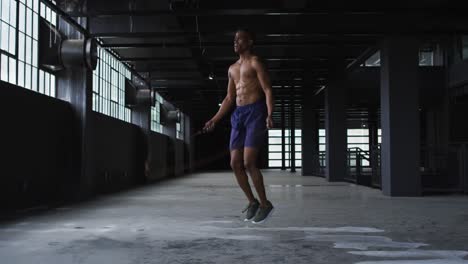 Shirtless-african-american-man-skipping-the-rope-in-an-empty-urban-building