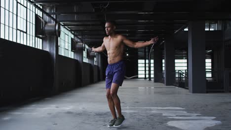 Shirtless-african-american-man-skipping-the-rope-in-an-empty-urban-building