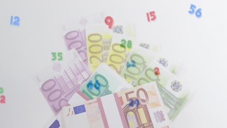 Digital-composition-of-multiple-numbers-and-symbols-floating-against-euro-bills