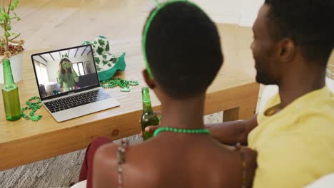 Afroamerikanisches-Paar-Auf-Laptop-Videoanruf,-Der-Mit-Freunden-Den-St.-Patrick&#39;s-Day-Feiert
