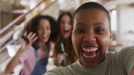 Diverse-group-of-female-friends-having-fun-taking-selfie-singing-karaoke-and-drinking-beer-at-home