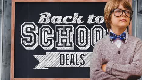 Animation-of-text-back-to-school-deals-on-chalkboard-with-smiling-schoolboy