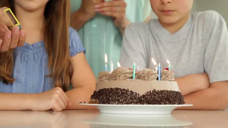 Animation-of-burning-layer-over-family-having-fun-at-birthday-party