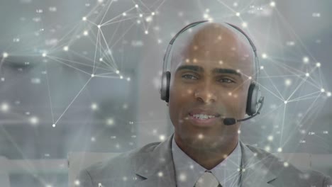 Animation-of-networks-of-connections-over-man-wearing-phone-headset