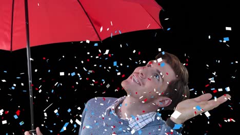 Animation-of-blue-and-red-confetti-over-man-with-umbrella-on-black-background