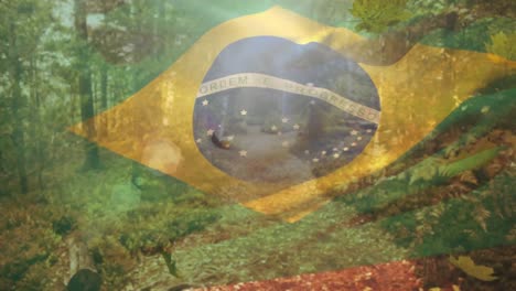 Composición-Digital-De-Brasil-Ondeando-La-Bandera-Sobre-Las-Hojas-De-Otoño-Cayendo-Contra-El-Camino-Del-Bosque