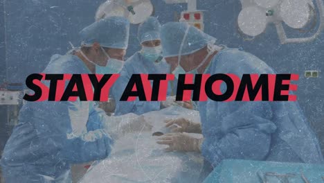 Stay-at-home-and-be-safe-text-against-team-of-surgeons-performing-surgery-at-operation-theatre