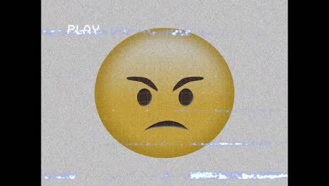 Digital-animation-of-vhs-effect-over-angry-face-emoji-against-grey-background