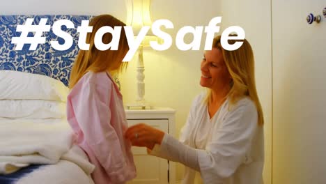 Animation-of-stay-safe-text-over-mother-and-daughter-at-home