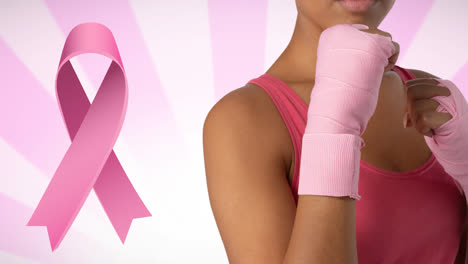 Animation-of-pink-ribbon-logo-over-women-guarding