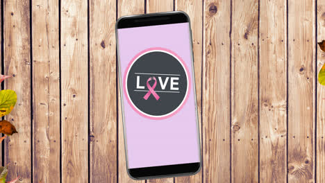 Animation-of-pink-breast-cancer-ribbon-logo-with-love-text-on-smartphone-screen