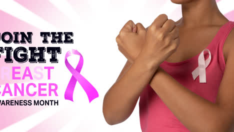 Animation-of-pink-ribbon-logo-with-breast-cancer-text-over-women-with-crossed-fists