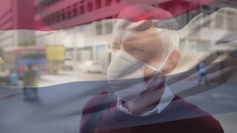 Animation-of-flag-of-luxembourg-over-man-wearing-face-mask