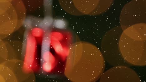 Animation-of-snow-falling-over-red-christmas-present-decoration