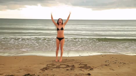 Gorgeous-brunette-dancing-around-with-2013-written-in-the-sand