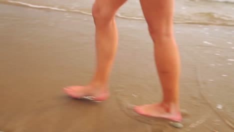 Woman-walking-along-the-tide