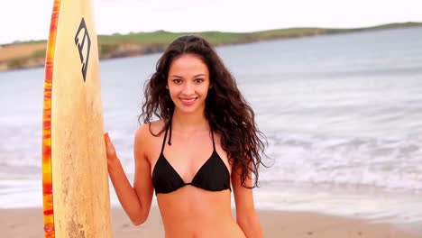 Gorgeous-brunette-surfer-smiling-at-the-camera