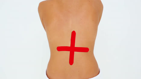 Woman-having-red-kinesio-tape-applied-to-back