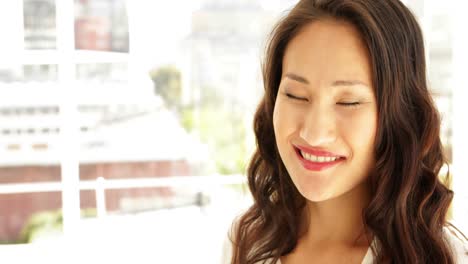 Asian-businesswoman-smiling-at-camera
