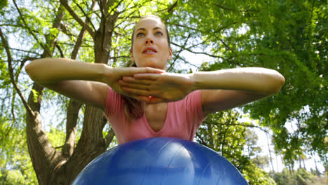 Fit-woman-doing-core-exercises-on-exercise-ball-in-the-park