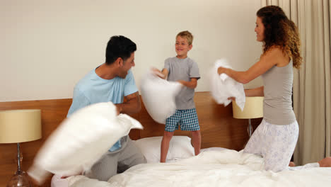 Parents-and-son-having-a-pillow-fight