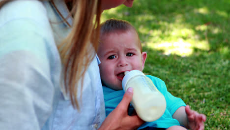Mother-feeding-her-cute-baby-son-his-bottle