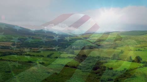 Digitale-Komposition-Der-Schwenkenden-US-Flagge-Vor-Der-Luftaufnahme-Des-Graslandes