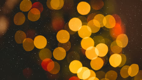 Animation-of-snow-falling-over-blurred-christmas-lights