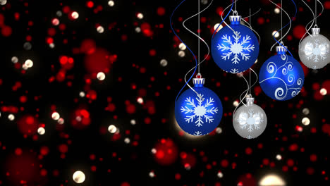 Animation-of-christmas-bubbles-over-spots-on-black-background