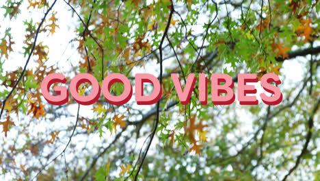 Animation-of-good-vibes-text-over-autumn-trees