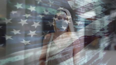 Animation-of-flag-of-usa-waving-over-caucasian-woman-wearing-face-mask-in-city-street