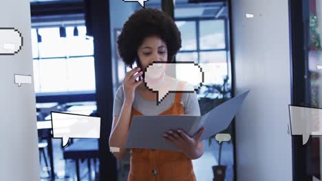 Animation-of-speech-bubbles-over-african-american-businesswoman-talking-on-smartphone