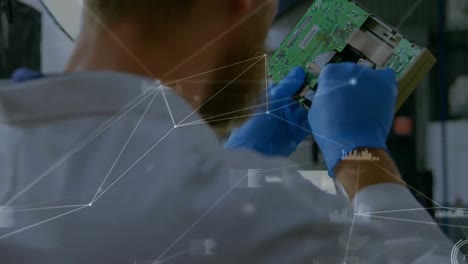 Animation-of-network-of-connections-over-caucasian-man-repairing-computer-hardware