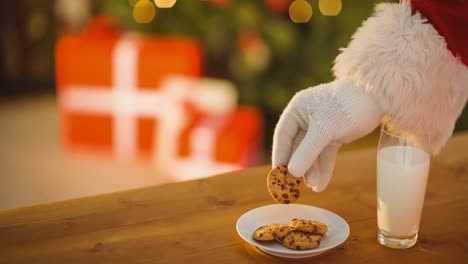 Animation-of-santa-claus-hand-taking-christmas-cookies-from-plate