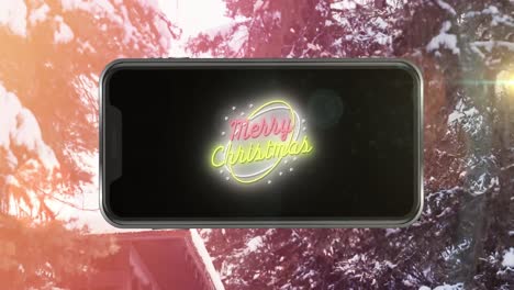 Animation-of-merry-christmas-text-in-smartphone-over-fir-trees