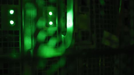 Close-up-of-green-control-lights-on-computer-servers-in-tech-room